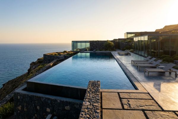 Saltwater pool with a sheer-descent waterfall and glass mosaic tile