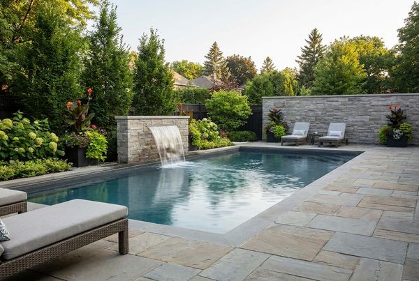 Small pool with a sheer descent waterfall on a raised wall