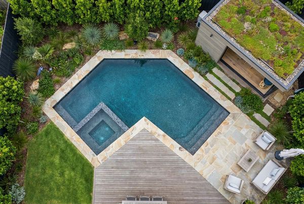 Small rectangular pool beside a covered patio
