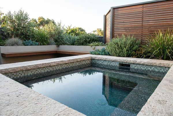 Small pool bordered by low modern planting