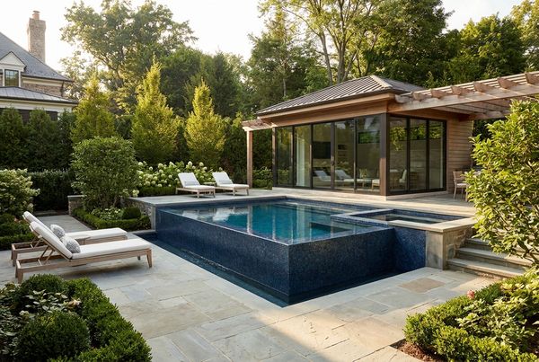 Small pool with a raised spillover spa