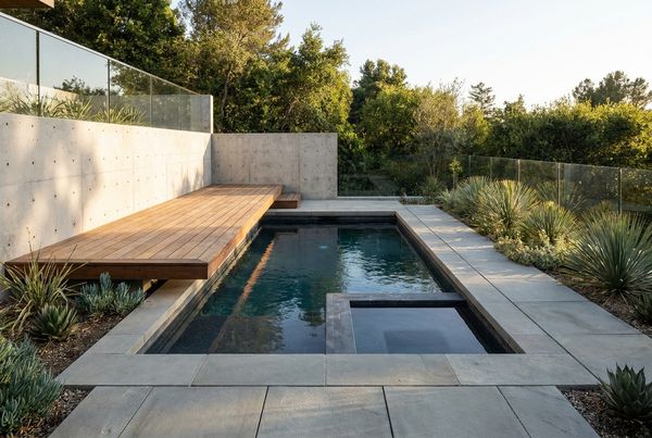 Small pool with a wood deck and built-in bench seating