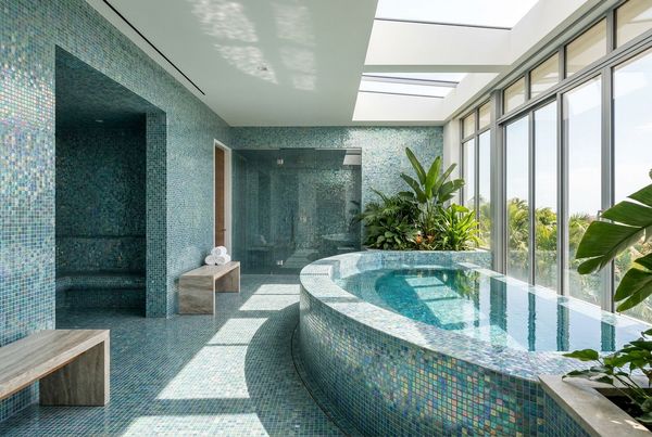 Spillover spa with glass mosaic tile on the spillway face