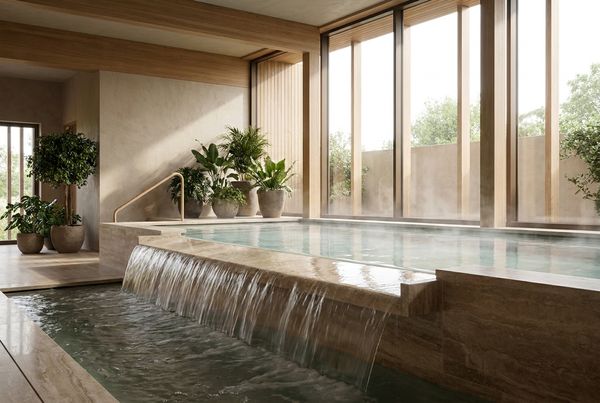 Spillover spa with a wide spillway sheeting evenly into the pool
