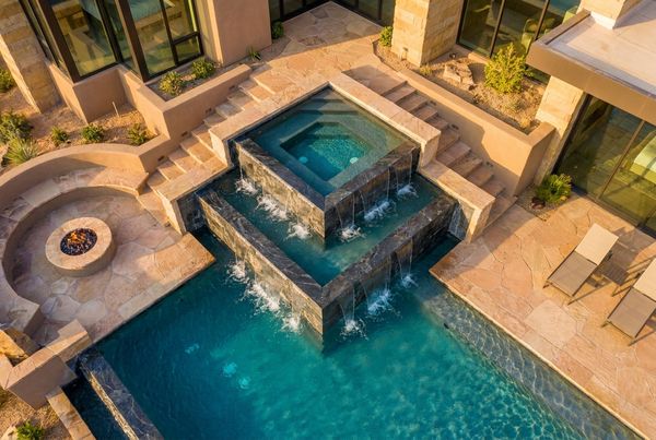 Square modern spillover spa with clean tiled facing