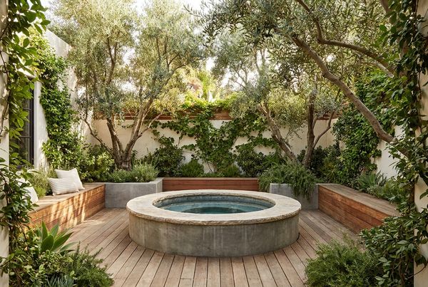 Dark-tiled spool pool with warm evening lighting
