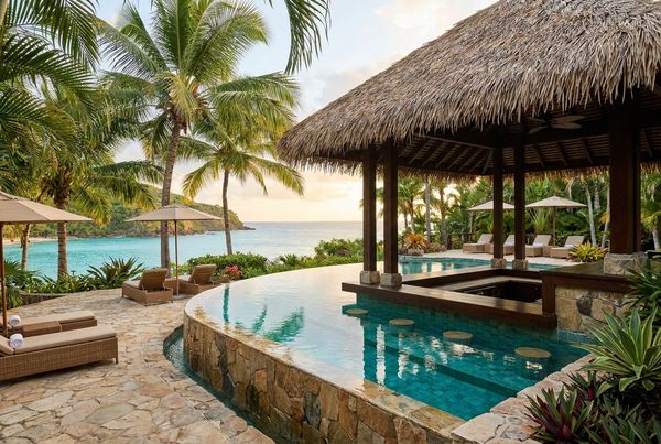 Tropical-style pool with a bar and lush green backdrop